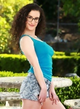 Bookworm with glasses showing her hairy armpits and pussy outdoors