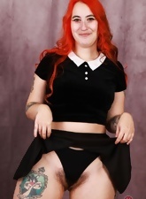 Chubby redhead with bush poses in solo pussy pics
