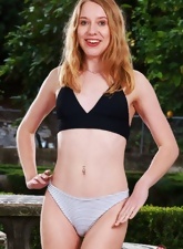 Outdoor posing gallery with a playful redhead teenager