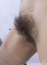 Cathy stripping naked, she shows us her hairy pussy and bush