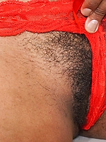 Ebony babe in red stockings flaunts natural tits and hairy pussy in bold spread pose